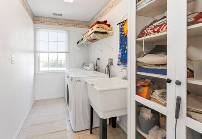 A convenient 2nd Floor Laundry Room with washtub sink and room for a storage cabinet and shelving.
