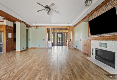 A custom fireplace, built-in cabinetry, and architectural wood accents anchor this living space, offering both style and comfort in a well-appointed Phoenix home.