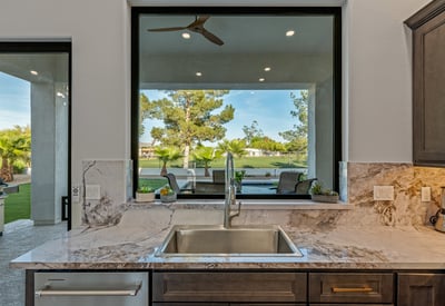 Scenic backyard and pool views from the kitchen sink enhance daily living in this beautifully updated Scottsdale home.