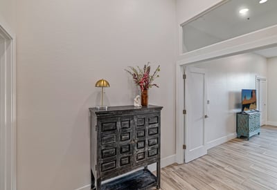 Hallway access connects the primary suite to an additional bedroom or office, offering versatile living space.