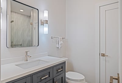 Connected directly to the bedroom, this en-suite bathroom boasts a modern vanity, quality finishes, and a fresh, contemporary design.