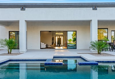 This expansive patio area offers poolside views and a shaded retreat, perfect for outdoor relaxation and entertaining in Scottsdale.