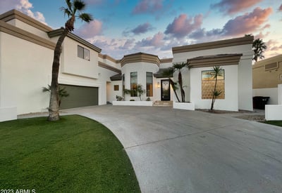 Evening glow illuminates the home s bold lines and architectural beauty, framed by soft desert light.