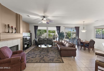 Expansive windows brighten this inviting living space, highlighting the seamless connection to the private backyard and showcasing the best of Arizona indoor-outdoor living.