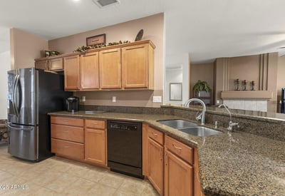 Enjoy a kitchen that blends warmth and practicality, offering expansive countertops, ample cabinets, and a seamless connection to the main living area.
