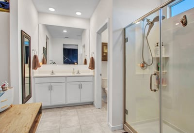 With dual sinks, ample counter space, and a large framed mirror, this bathroom offers both practicality and comfort in this Litchfield Park home.