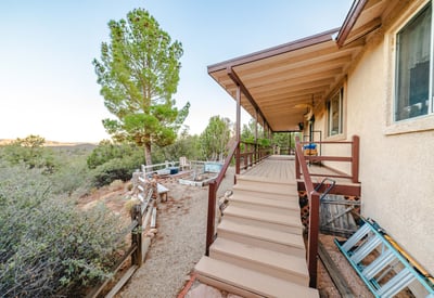 Highlighted by exposed beams and rich wood textures, this great room creates a welcoming retreat. Expansive windows bring in mountain views and natural light, reinforcing the home s seamless connection to Hackberry s peaceful environment.