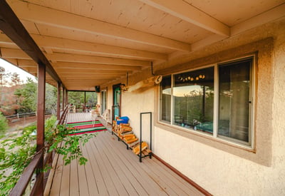 With extended shade and space for seating, this porch offers expansive forest and mountain views. A refreshing retreat surrounded by desert greenery.