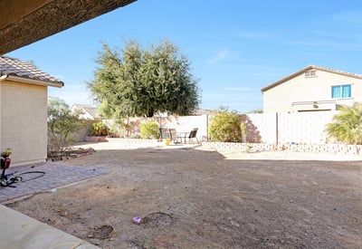 Sliding door view highlighting the expansive backyard and natural light, enhancing the home s open and airy feel.