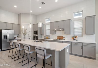 Eye-catching kitchen centerpiece featuring a large quartz island, premium cabinetry, and gas cooktop, ideal for entertaining and everyday cooking.
