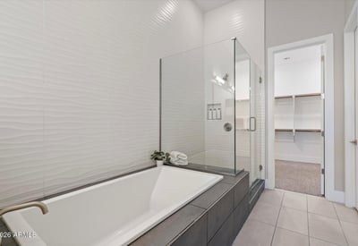 Luxury bathroom escape with soaking tub, glass-enclosed shower, and stylish tile accents for everyday indulgence.