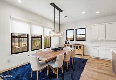 Bright dining space with modern lighting and open flow to the kitchen. Ideal for entertaining guests or enjoying everyday dining in this Scottsdale luxury home.