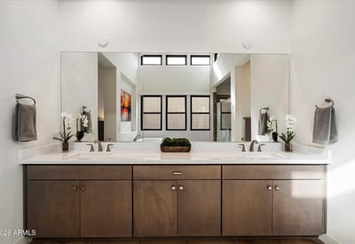 Contemporary primary bathroom with dual vanities, sleek hardware, and ample counter space. Designed for everyday luxury living in Scottsdale.