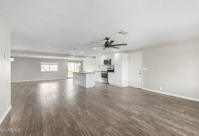Wide-open living space with neutral tones, recessed lighting, and updated flooring perfect for comfortable everyday living and entertaining in this Phoenix home for sale.