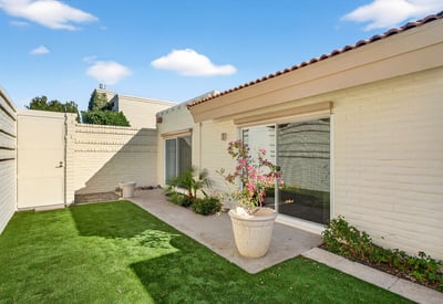 Peaceful courtyard backyard with turf and patio space, ideal for relaxing, entertaining, or enjoying Phoenix s outdoor lifestyle.