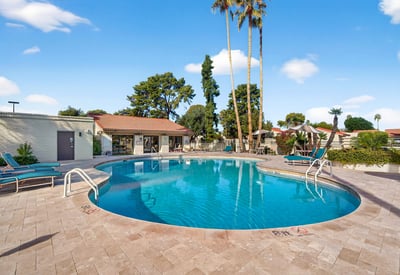 Spacious community pool area offering shaded seating, open sun areas, and a welcoming environment for leisure and relaxation.