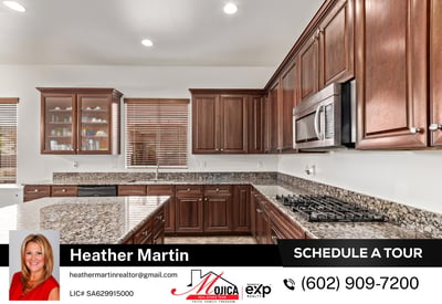 The oversized island offers seating potential and plenty of prep room. Stainless steel appliances and custom cabinetry complete the look in this beautifully maintained Glendale kitchen.
