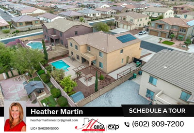 Rear aerial perspective displays the full backyard oasis with covered patio and pool. Solar panels provide energy efficiency, making this Glendale home both stylish and practical.