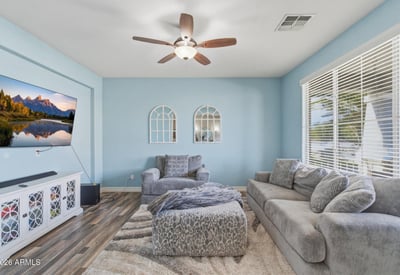 Comfortable living space with wide windows, neutral finishes, and modern flooring creating a bright and relaxing atmosphere inside this Queen Creek home.