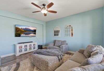 Front living room featuring soft natural light, updated flooring, and comfortable seating space perfect for relaxing or welcoming guests.