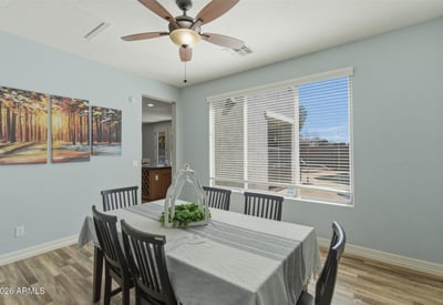 Dining space overlooking the backyard retreat with pool and spa, allowing natural light to fill the room and connecting indoor dining with outdoor living.