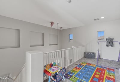 Large loft area overlooking the main entry, offering flexible space for a playroom, lounge, or second living room.