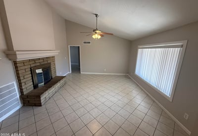 Large living area with vaulted ceilings, tile floors, and a fireplace feature wall. The open design creates a comfortable setting for entertaining in this Glendale property.