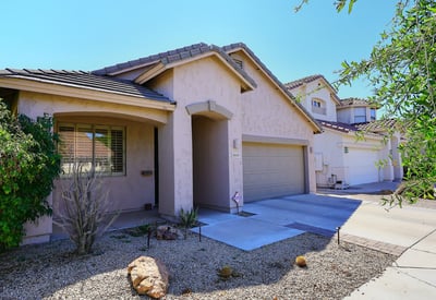 Angled exterior view highlighting the home s design, landscaping, and driveway. This Phoenix property offers appealing curb presence.