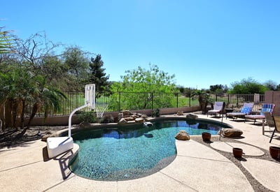 Backyard pool with unobstructed golf course views and desert landscaping. This Phoenix home offers privacy, open space, and resort-style outdoor features.