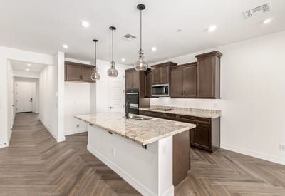 Modern kitchen with oversized island, granite counters, pendant lighting, and ample storage. Perfect blend of style and functionality.