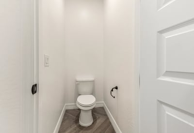 Private water closet providing additional comfort and separation within the primary bathroom.
