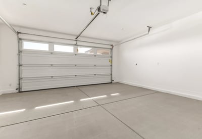 Two-car garage featuring clean finishes, automatic opener, and space for storage or workshop setup in this Peoria home.