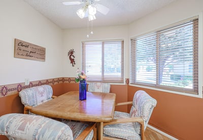 Bright breakfast nook with large windows, warm tones, and cozy seating perfect for casual dining and morning gatherings.