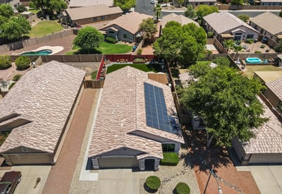 Aerial perspective showcasing solar panels, roof condition, and backyard space. Energy-efficient features add value and long-term savings.