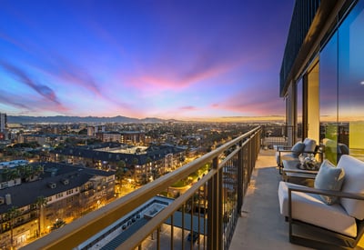 Spacious balcony capturing vibrant sunset colors and panoramic Phoenix city views, ideal for evening relaxation and entertaining.