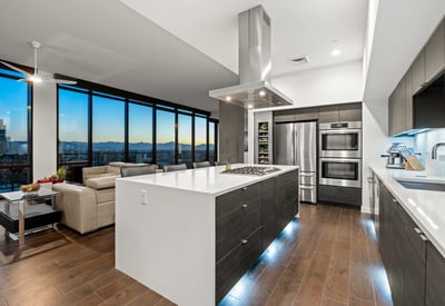 Contemporary kitchen with expansive island and panoramic Phoenix views, enhanced by energy-efficient appliances and modern finishes.
