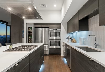 Stylish kitchen with integrated bar seating, quartz counters, and premium finishes, offering both function and elegance in this Phoenix property.