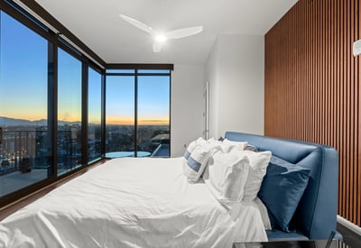 Spacious primary suite with balcony access, modern finishes, and expansive Phoenix views, offering a private and relaxing retreat.