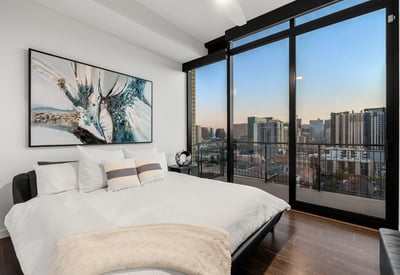 Inviting secondary bedroom with large windows, natural light, and clean modern finishes, perfect for guests or home office use.