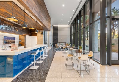 Light-filled lobby featuring expansive glass walls and contemporary furnishings, enhancing the modern feel of this Phoenix property.