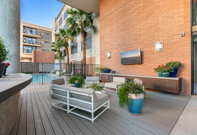 Poolside retreat featuring lounge seating, grilling area, and landscaped surroundings, offering resort-style amenities in Phoenix.