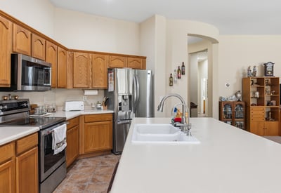 Kitchen featuring stainless steel appliances, spacious counters, and efficient layout, enhancing everyday living in this Phoenix property.