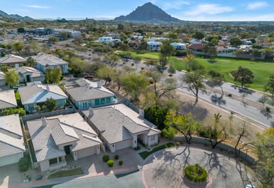 Aerial view showcasing a peaceful cul-de-sac with attractive homes, landscaped streets, and convenient access to main roads in Phoenix.