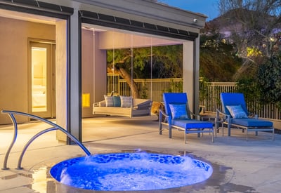 Serene spa with bubbling water feature next to a covered seating area, offering a private Scottsdale outdoor escape for relaxation and entertaining.
