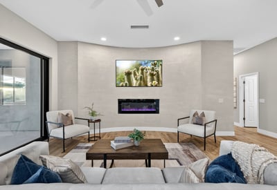 Contemporary Scottsdale living room showcasing a sleek fireplace, neutral tones, and updated finishes, creating a comfortable and stylish gathering space.