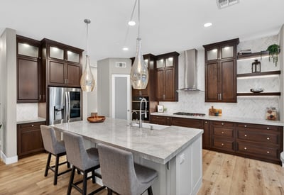 High-end kitchen with quartz island, farmhouse sink, custom cabinetry, and stainless steel appliances in this Scottsdale home.