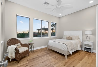 Scottsdale bedroom with multiple windows, wood flooring, and abundant natural light, creating an open and airy feel.