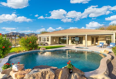 Scottsdale backyard with pool, spa, and covered patio overlooking scenic mountain views, perfect for outdoor entertaining.