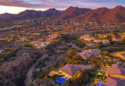 Scottsdale aerial showcasing natural desert terrain, nearby homes, and open space enhancing privacy and views.