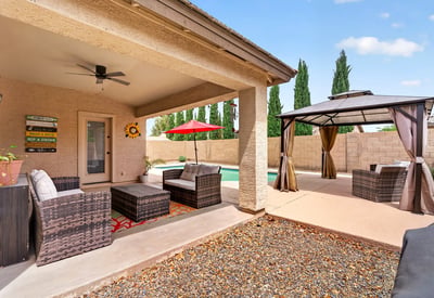 Covered patio with seating and views of the pool and pergola area. Designed for entertaining and enjoying Arizona-style outdoor living in Casa Grande.